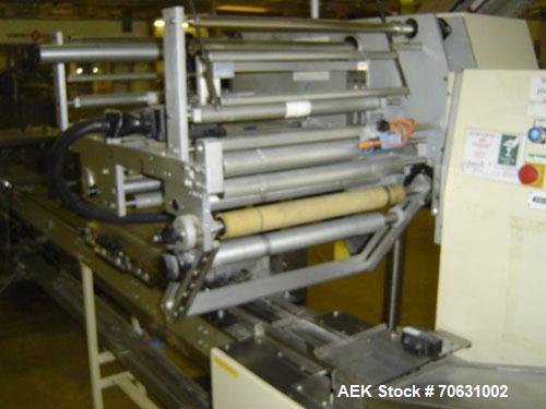 Used Otem M300DX Flowpack Wrapper.  Maximum pack height 3.5" (90 mm).  Maximum pack length 15" (380 mm).  Knives 9.4" (240 mm) long.  Maximum pack width 7.8" (200 mm).  Optional cardboard base feeder...