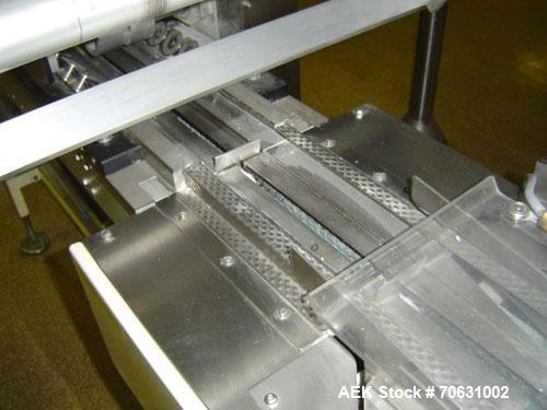 Used Otem M300DX Flowpack Wrapper.  Maximum pack height 3.5" (90 mm).  Maximum pack length 15" (380 mm).  Knives 9.4" (240 mm) long.  Maximum pack width 7.8" (200 mm).  Optional cardboard base feeder...