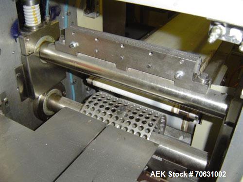 Used Otem M300DX Flowpack Wrapper.  Maximum pack height 3.5" (90 mm).  Maximum pack length 15" (380 mm).  Knives 9.4" (240 mm) long.  Maximum pack width 7.8" (200 mm).  Optional cardboard base feeder...