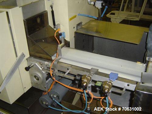 Used Otem M300DX Flowpack Wrapper.  Maximum pack height 3.5" (90 mm).  Maximum pack length 15" (380 mm).  Knives 9.4" (240 mm) long.  Maximum pack width 7.8" (200 mm).  Optional cardboard base feeder...