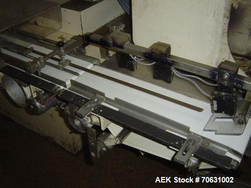 Used Otem M300DX Flowpack Wrapper.  Maximum pack height 3.5" (90 mm).  Maximum pack length 15" (380 mm).  Knives 9.4" (240 mm) long.  Maximum pack width 7.8" (200 mm).  Optional cardboard base feeder...