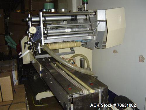 Used Otem M300DX Flowpack Wrapper.  Maximum pack height 3.5" (90 mm).  Maximum pack length 15" (380 mm).  Knives 9.4" (240 mm) long.  Maximum pack width 7.8" (200 mm).  Optional cardboard base feeder...