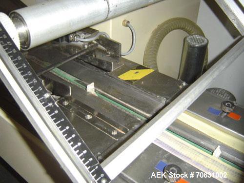 Used Otem M300DX Flowpack Wrapper.  Maximum pack height 3.5" (90 mm).  Maximum pack length 15" (380 mm).  Knives 9.4" (240 mm) long.  Maximum pack width 7.8" (200 mm).  Optional cardboard base feeder...