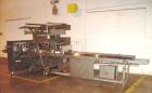 Used Doboy Horizontal Wrapper, Model J. Capable of speeds over 200 packages per minute. Has extended height seal, side belt product infeed belts, film registration, 1 up sealing head 8