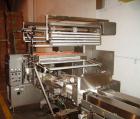 Used Doboy Horizontal Wrapper, Model J. Capable of speeds over 200 packages per minute. Has extended height seal, side belt product infeed belts, film registration, 1 up sealing head 8