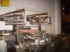 Used Doboy Horizontal Wrapper, Model J. Capable of speeds over 200 packages per minute. Has extended height seal, side belt product infeed belts, film registration, 1 up sealing head 8