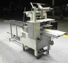 Used Doboy Model Scotty II Horizontal Flow Wrapper. Machine is capable of speeds up to 60 packages per minute. Has 6' Long lugged Carrier Style chain infeed on 12” centers. Package size range: (lengt...