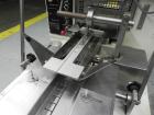 Used Doboy Model Scotty II Horizontal Flow Wrapper. Machine is capable of speeds up to 60 packages per minute. Has 6' Long lugged Carrier Style chain infeed on 12” centers. Package size range: (lengt...