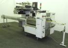 Used FMC Model WM20 SynchroFlo Horizontal Wrapper. Speeds up uo 300 packages per minute. 2 up cutting head, 1 1/2