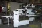 Used FMC Model WM20 SynchroFlo Horizontal Wrapper. Speeds up uo 300 packages per minute. 2 up cutting head, 1 1/2