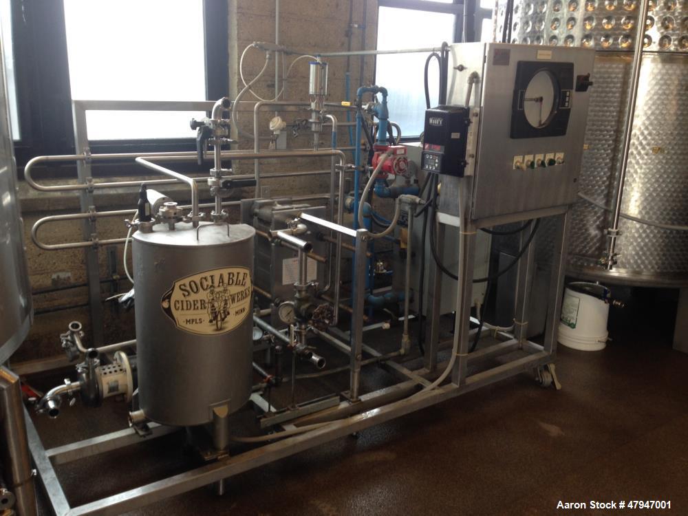 Used APV Apple Cider Pasteurizer. Plate and frame heat exchanger, on skid. Model PPAC-05, Apple cider flowrate at 40 degrees F: 5 GPM. Hot water flowrate at 185 degrees F: 10 GPM. 47,000 heating BTUs...
