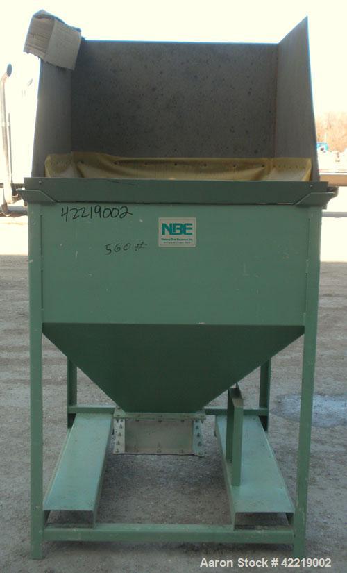 Used NBE Dry Bulk Storage Hopper, approximately 40 cubic feet, carbon steel. 44" wide x 44" long x 18" deep x coned bottom. Approximate 1400 pound capacity. Includes a top extension and grate. Mounte...