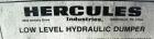 Used Hercules Industries Low Level Hydraulic Drum Dumper. Approximately 750 pound capacity, carbon steel frame, stainless steel discharge chute with 8