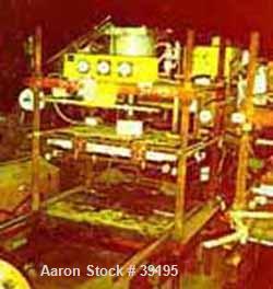 USED: Hot melt stamping press, downacting, 4 post type. 2" diameter threaded rod. Electrically heated platen 23" front-back x 35" left-right. Measurement between posts 29" x 41". 29" daylight. 4" dia...