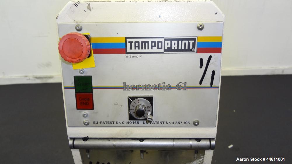 Used Tampo Print Pad Printer, Model Hermetic 61. Single cycle, approximately 1300-1400 per hour. Ink doctoring cup 60 mm, cliché size 70 mm x 140 mm, maximum print image size 55 mm. Includes foot ped...