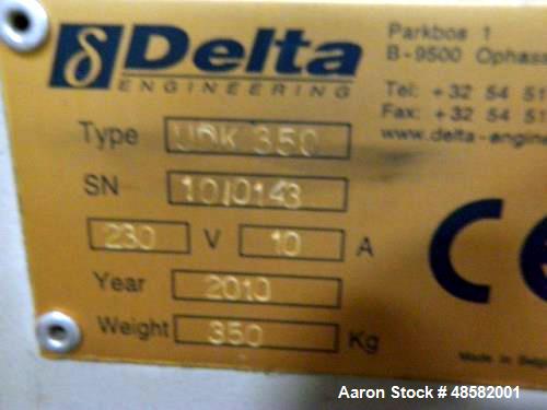 Used Delta On the Fly Leak Tester, Model UDK 350. One head, specifically designed for the testing of plastic empty bottles. on the fly" movement, bottles are never stopped (no accumulation). No bottl...