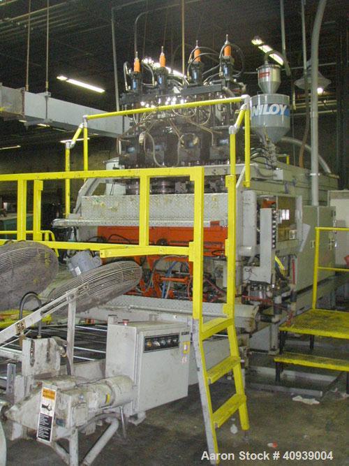 Used Uniloy Model 400R20, Serial #4983 Reciprocating Blow Molder. No side shift. Has 4 head design on 14" centers. Overall clamp is 21.5" top to bottom X 68" wide. 6 tie bar clamp with (2) compartmen...