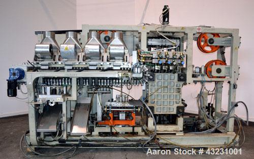 Used Uniloy Milacron Alkam Stretch Blow Molding Machine, Model BM-4. (4) Blow cavities/mould, 130mm distance between cavities. Unit includes an infeed system with a hopper, elevator, orienter, and in...