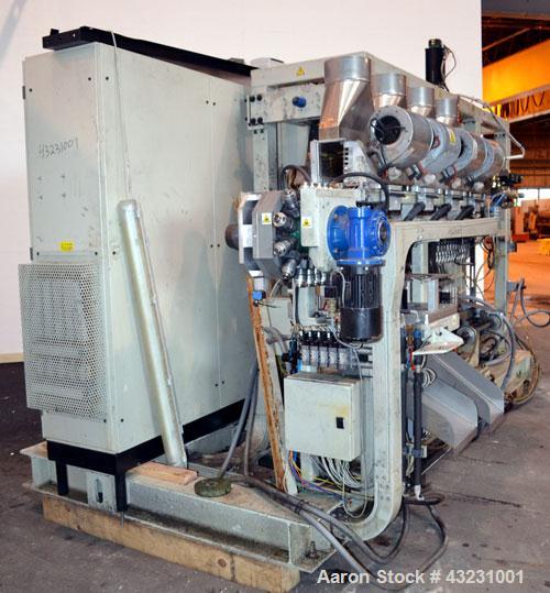 Used Uniloy Milacron Alkam Stretch Blow Molding Machine, Model BM-4. (4) Blow cavities/mould, 130mm distance between cavities. Unit includes an infeed system with a hopper, elevator, orienter, and in...