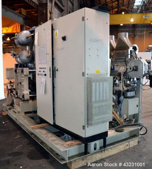 Used Uniloy Milacron Alkam Stretch Blow Molding Machine, Model BM-4. (4) Blow cavities/mould, 130mm distance between cavities. Unit includes an infeed system with a hopper, elevator, orienter, and in...