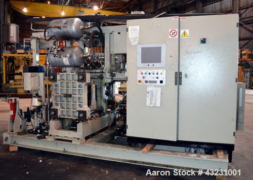 Used Uniloy Milacron Alkam Stretch Blow Molding Machine, Model BM-4. (4) Blow cavities/mould, 130mm distance between cavities. Unit includes an infeed system with a hopper, elevator, orienter, and in...