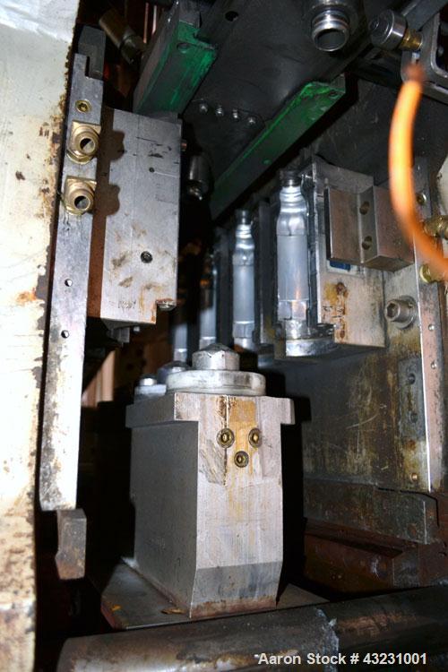 Used Uniloy Milacron Alkam Stretch Blow Molding Machine, Model BM-4. (4) Blow cavities/mould, 130mm distance between cavities. Unit includes an infeed system with a hopper, elevator, orienter, and in...