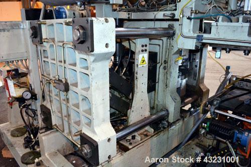 Used Uniloy Milacron Alkam Stretch Blow Molding Machine, Model BM-4. (4) Blow cavities/mould, 130mm distance between cavities. Unit includes an infeed system with a hopper, elevator, orienter, and in...