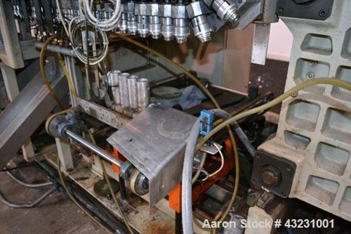 Used Uniloy Milacron Alkam Stretch Blow Molding Machine, Model BM-4. (4) Blow cavities/mould, 130mm distance between cavities. Unit includes an infeed system with a hopper, elevator, orienter, and in...