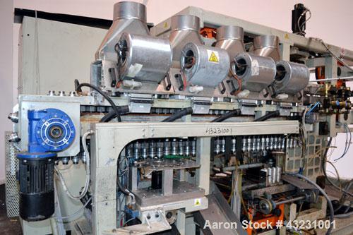 Used Uniloy Milacron Alkam Stretch Blow Molding Machine, Model BM-4. (4) Blow cavities/mould, 130mm distance between cavities. Unit includes an infeed system with a hopper, elevator, orienter, and in...