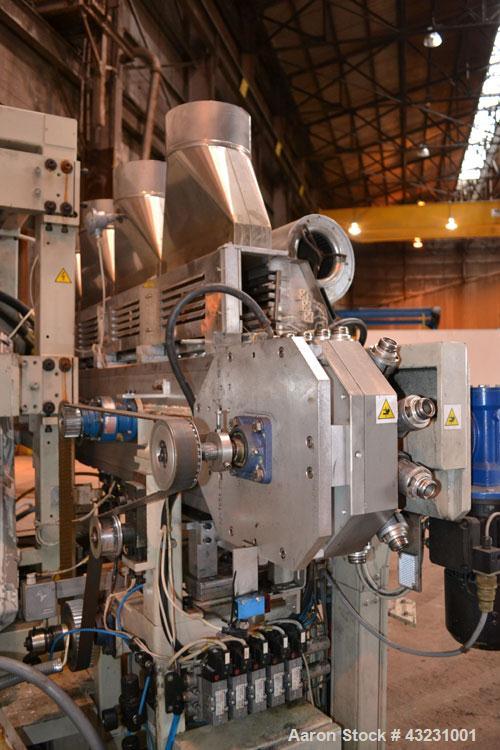 Used Uniloy Milacron Alkam Stretch Blow Molding Machine, Model BM-4. (4) Blow cavities/mould, 130mm distance between cavities. Unit includes an infeed system with a hopper, elevator, orienter, and in...