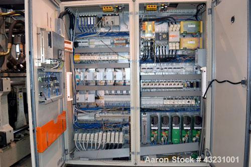 Used Uniloy Milacron Alkam Stretch Blow Molding Machine, Model BM-4. (4) Blow cavities/mould, 130mm distance between cavities. Unit includes an infeed system with a hopper, elevator, orienter, and in...