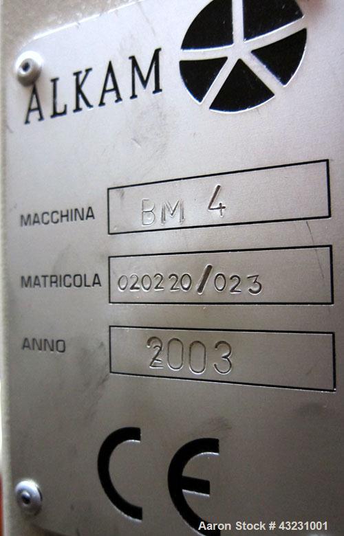 Used Uniloy Milacron Alkam Stretch Blow Molding Machine, Model BM-4. (4) Blow cavities/mould, 130mm distance between cavities. Unit includes an infeed system with a hopper, elevator, orienter, and in...