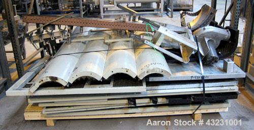 Used Uniloy Milacron Alkam Stretch Blow Molding Machine, Model BM-4. (4) Blow cavities/mould, 130mm distance between cavities. Unit includes an infeed system with a hopper, elevator, orienter, and in...