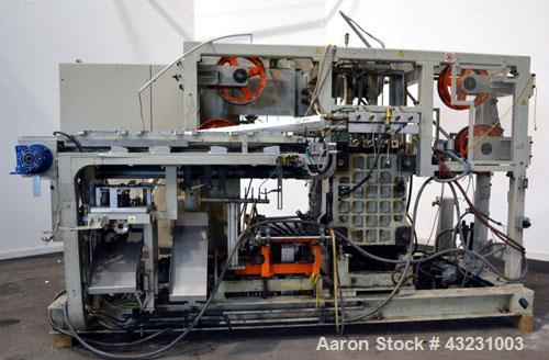Used Uniloy Milacron Alkam Stretch Blow Molding Machine, Model BM-5. (5) Blow cavities/mould, 105mm distance between cavities. Unit includes an infeed system with a hopper, elevator, orienter, and in...