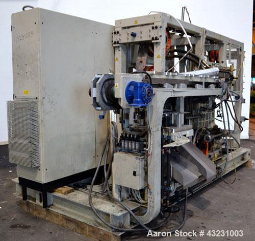 Used Uniloy Milacron Alkam Stretch Blow Molding Machine, Model BM-5. (5) Blow cavities/mould, 105mm distance between cavities. Unit includes an infeed system with a hopper, elevator, orienter, and in...