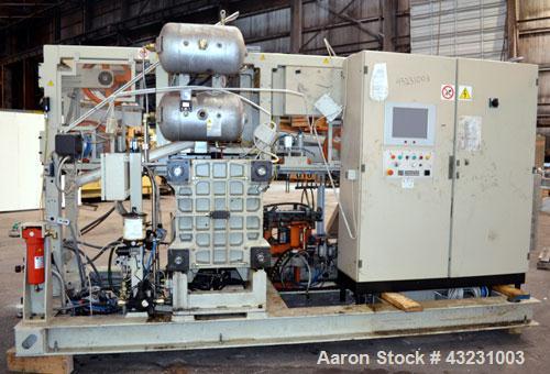 Used Uniloy Milacron Alkam Stretch Blow Molding Machine, Model BM-5. (5) Blow cavities/mould, 105mm distance between cavities. Unit includes an infeed system with a hopper, elevator, orienter, and in...