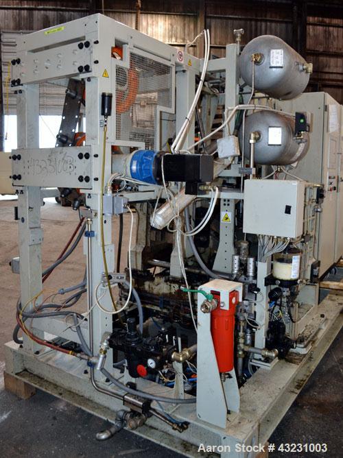 Used Uniloy Milacron Alkam Stretch Blow Molding Machine, Model BM-5. (5) Blow cavities/mould, 105mm distance between cavities. Unit includes an infeed system with a hopper, elevator, orienter, and in...