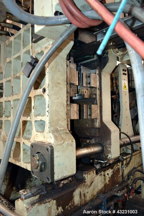 Used Uniloy Milacron Alkam Stretch Blow Molding Machine, Model BM-5. (5) Blow cavities/mould, 105mm distance between cavities. Unit includes an infeed system with a hopper, elevator, orienter, and in...