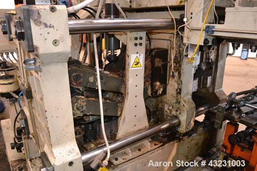 Used Uniloy Milacron Alkam Stretch Blow Molding Machine, Model BM-5. (5) Blow cavities/mould, 105mm distance between cavities. Unit includes an infeed system with a hopper, elevator, orienter, and in...