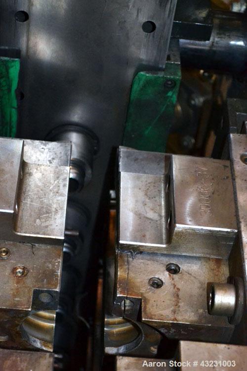 Used Uniloy Milacron Alkam Stretch Blow Molding Machine, Model BM-5. (5) Blow cavities/mould, 105mm distance between cavities. Unit includes an infeed system with a hopper, elevator, orienter, and in...