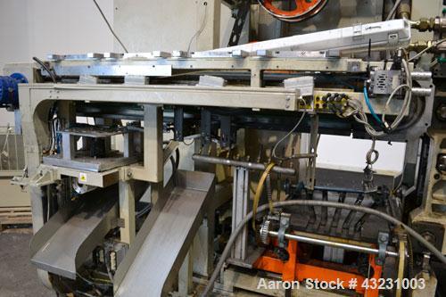 Used Uniloy Milacron Alkam Stretch Blow Molding Machine, Model BM-5. (5) Blow cavities/mould, 105mm distance between cavities. Unit includes an infeed system with a hopper, elevator, orienter, and in...