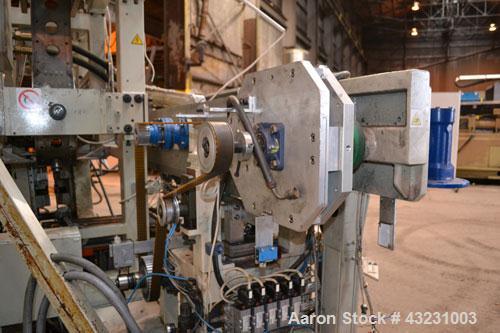 Used Uniloy Milacron Alkam Stretch Blow Molding Machine, Model BM-5. (5) Blow cavities/mould, 105mm distance between cavities. Unit includes an infeed system with a hopper, elevator, orienter, and in...