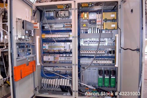 Used Uniloy Milacron Alkam Stretch Blow Molding Machine, Model BM-5. (5) Blow cavities/mould, 105mm distance between cavities. Unit includes an infeed system with a hopper, elevator, orienter, and in...