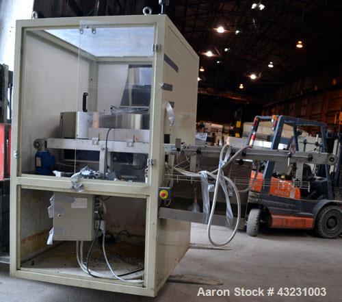 Used Uniloy Milacron Alkam Stretch Blow Molding Machine, Model BM-5. (5) Blow cavities/mould, 105mm distance between cavities. Unit includes an infeed system with a hopper, elevator, orienter, and in...