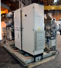 Used Uniloy Milacron Alkam Stretch Blow Molding Machine, Model BM-4. (4) Blow cavities/mould, 130mm distance between cavities. Unit includes an infeed system with a hopper, elevator, orienter, and in...