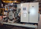 Used Uniloy Milacron Alkam Stretch Blow Molding Machine, Model BM-4. (4) Blow cavities/mould, 130mm distance between cavities. Unit includes an infeed system with a hopper, elevator, orienter, and in...