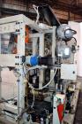 Used Uniloy Milacron Alkam Stretch Blow Molding Machine, Model BM-4. (4) Blow cavities/mould, 130mm distance between cavities. Unit includes an infeed system with a hopper, elevator, orienter, and in...