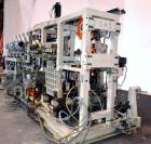 Used Uniloy Milacron Alkam Stretch Blow Molding Machine, Model BM-4. (4) Blow cavities/mould, 130mm distance between cavities. Unit includes an infeed system with a hopper, elevator, orienter, and in...