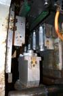 Used Uniloy Milacron Alkam Stretch Blow Molding Machine, Model BM-4. (4) Blow cavities/mould, 130mm distance between cavities. Unit includes an infeed system with a hopper, elevator, orienter, and in...