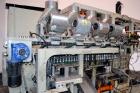 Used Uniloy Milacron Alkam Stretch Blow Molding Machine, Model BM-4. (4) Blow cavities/mould, 130mm distance between cavities. Unit includes an infeed system with a hopper, elevator, orienter, and in...